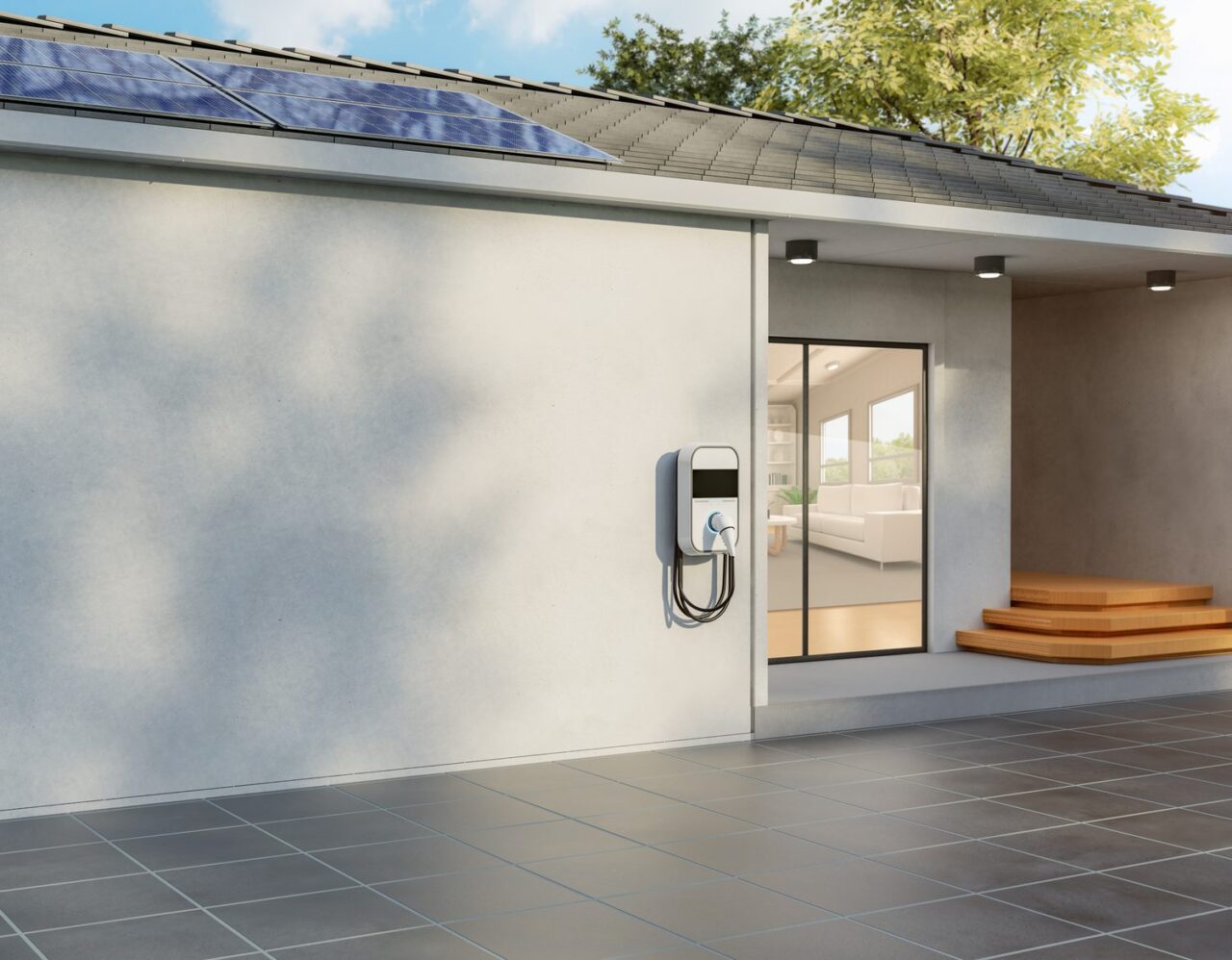 Borne de recharge installée dans un garage résidentiel, reliée au tableau électrique pour ajuster la puissance de charge.