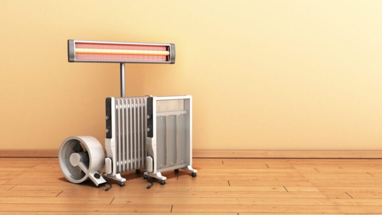 Radiateur électrique installé dans une pièce d’une maison mal isolée, près d’une fenêtre laissant entrer le froid.